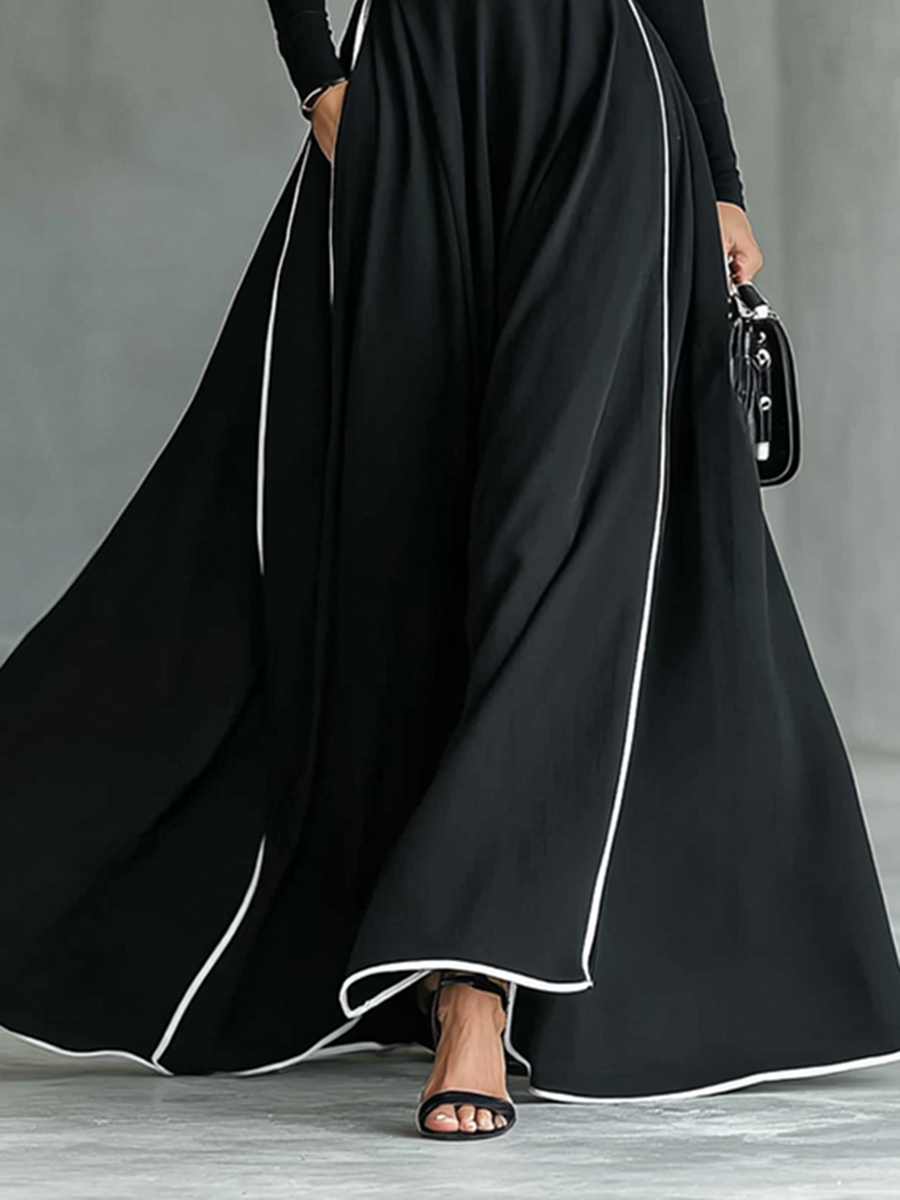 Nicole | Vestido maxi de mujer negro con costuras blancas, cuello alto, mangas largas y cintura entallada